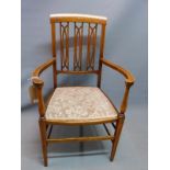 An Edwardian mahogany armchair, with boxwood inlay, raised on tapered legs, joined by stretcher