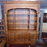 A William IV style pine pine bookcase, with four doors raised on stepped base, H.320 W.188 D.46cm