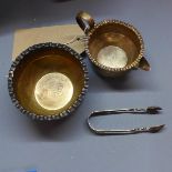 A Victorian silver bowl and matching milk jug, with scalloped rim and repousse embossed with