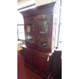 A mahogany bookcase with two glass fronted doors, H.210 W.120cm