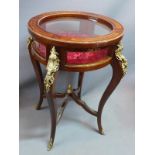 A Louis XV style circular walnut bijouterie cabinet, with brass mounts, raised on cabriole legs