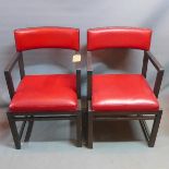 A pair of oak armchairs, with red leather seats