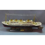 A hand painted model of the Titanic, bears plaque to ebonised base, H.24 W.49cm