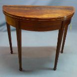 A 19th century mahogany demi lume card table, with boxwood inlay, raised on tapered legs and spade