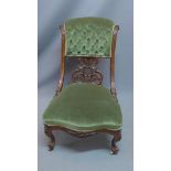 A Victorian mahogany nursing chair, with green velour upholstery, raised on cabriole legs