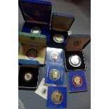 A collection of nine individually cased commemorative coins, (9)