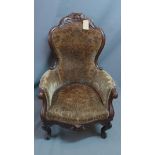 A Victorian mahogany armchair, with damask upholstery, raised on cabriole legs