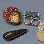 An Art Nouveau style white metal and hardstone brooch decorated with a tree, together with a
