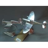 A pair of chrome desk top models of planes