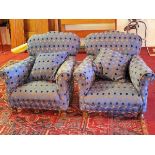 A pair of Howard style armchairs with blue linen upholstery, having yellow, black and blue spots