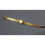A Rolex Precision 9ct yellow gold ladies wristwatch, the silvered dial with gilt baton markers, with