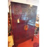 A Chinese cabinet with carved upper drawers, H.183 W.110 D.59cm