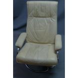 A Danish cream leather reclining swivel armchair by Kebe, raised on chrome base, bears label