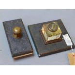 A cut glass inkwell raised on a square slate stand, together with a slate blotter with brass handle,