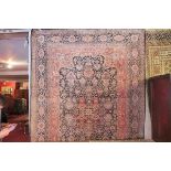 An extremely fine Indian pure silk carpet, having central floral motifs, on a dark blue ground,