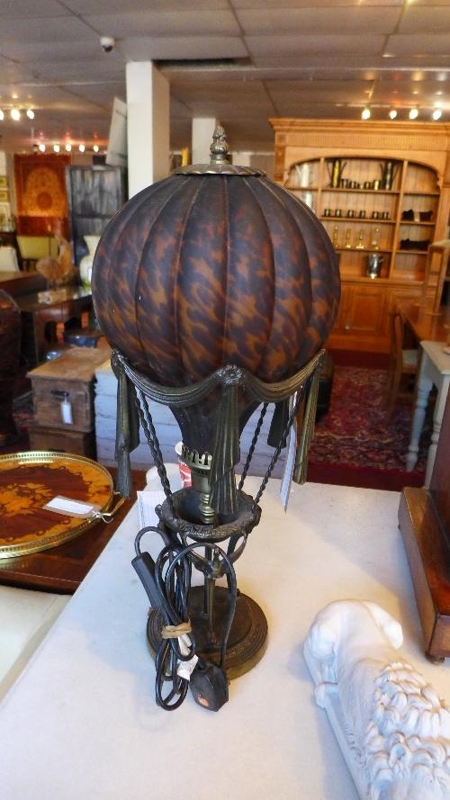 A Maitland Smith table lamp in the form of a hot air balloon, with tortoiseshell effect glass shade