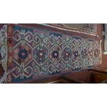 WITHDRAWN An antique Kelim runner, with eight geometric pole medallion, on a red and blue ground,