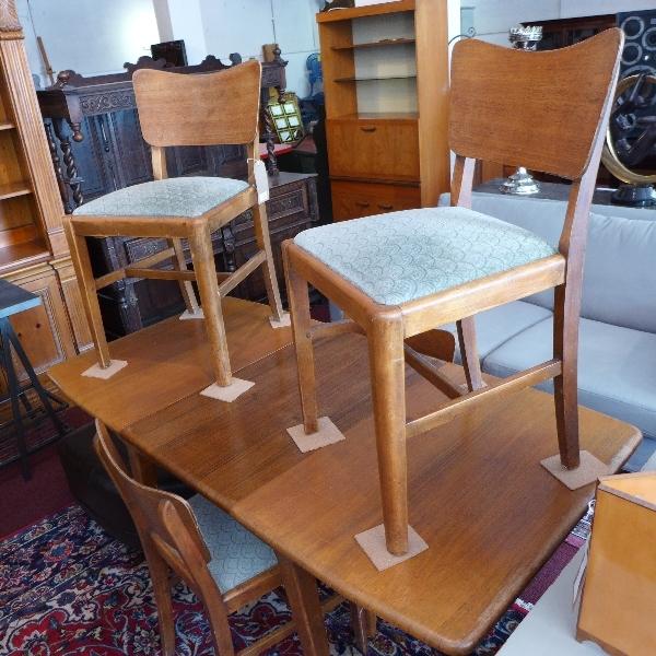 A mid 20th century teak dining table and four chairs