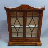 A 19th century rosewood table top bookcase, with two glazed doors over two drawers, raised on plinth