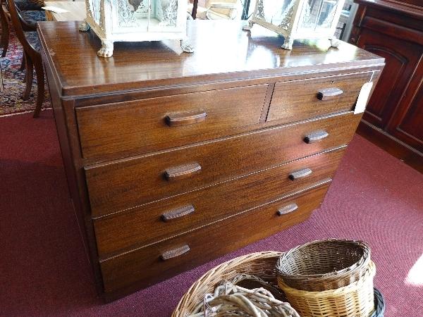 A mid 20th century mahogany chest of two short over three long drawers, raised on plinth base,
