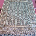 A Bokhara style carpet, with elephant pad motifs on a green ground contained by geometric border,