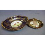 Two 19th century porcelain dishes painted with birds, having cobalt blue and gilt border, (a/f)