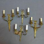 Two pairs of gilt metal wall lights in the Classical taste