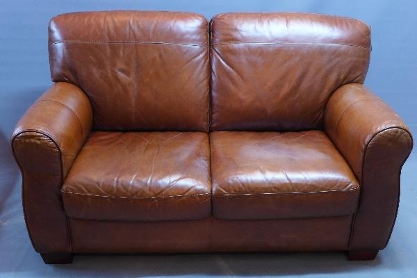 A Contemporary tan leather two seater sofa