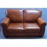 A Contemporary tan leather two seater sofa