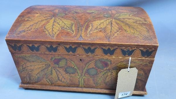 A 19th / 20th century German dome top casket, carved and painted with conker trees, raised on bun