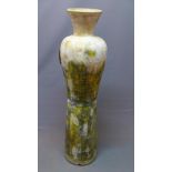 A tall earthenware floor vase, with distressed polychrome decoration, H.120cm