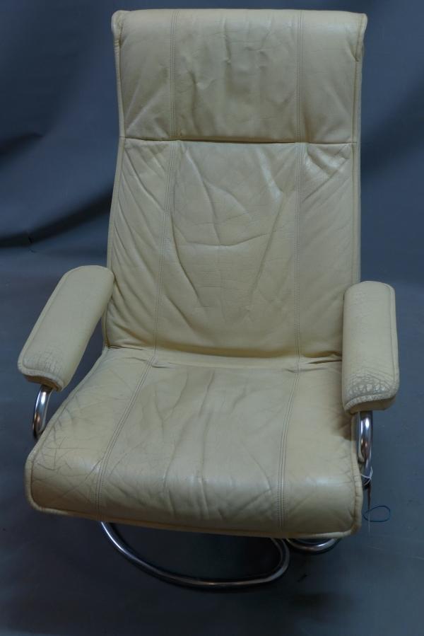 A Danish cream leather reclining swivel armchair by Kebe, raised on chrome base, bears label