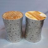 A pair of aluminium and teak side tables, having floral decoration, H.46cm