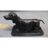 A cast bronze dachshund, raised on stepped marble base, H.17 W.30cm