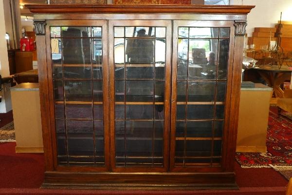 A William IV rosewood bookcase, having three glazed doors, raised on stepped base, H.166 W.190 D.