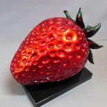 A Contemporary fiberglass strawberry on plaque