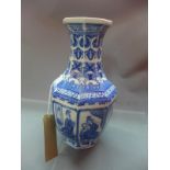 A Chinese octagonal blue and white porcelain vase, decorated with panels of women below flowers,