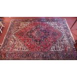 WITHDRAWN A Heriz carpet, with central geometric floral medallion, contained by many geometric