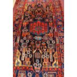 A fine North West Persian Nahavand rug, having a central double pendant on a sapphire field
