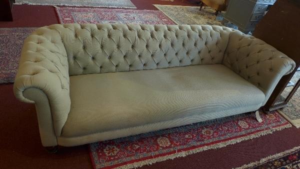 A grey three seater Chesterfield sofa, L.200 H.65 D.85cm