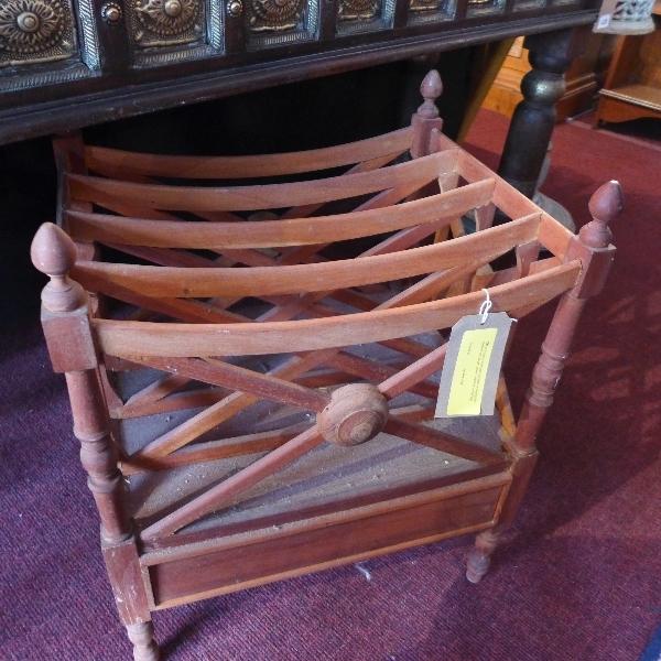 A Regency style teak Canterbury, having four divisions and single drawer, raised on turned legs