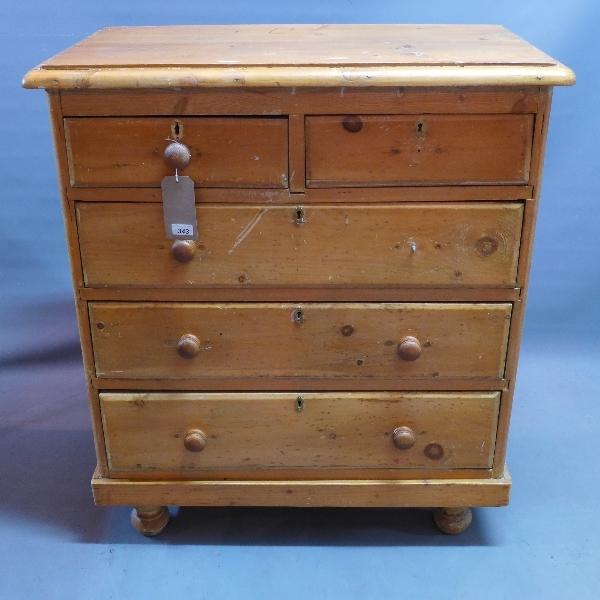 A Victorian pine chest of two short over three long drawers, raised on bun feet, H.106 W.93 D.48cm