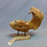 A rustic teak carving of a fish, raised on stand, H.45cm