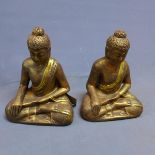 A pair of gilt painted resin figures of seated Buddhas, H.32cm (2)