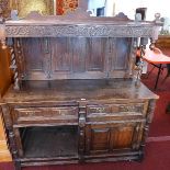 An 18th century oak dresser, with superstructure over two drawers and two cupboard doors, carved