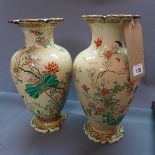 A pair of 19th century Japanese ceramic vases, hand painted with flora and fauna, H.32 cm, (a/f)