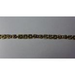 A ladies 9ct yellow gold and diamond inset bracelet, decorated with bows inset with diamonds, marked