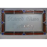 An early 20th century stained glass panel sign for 'Stained Glass Workshop', 36 x 66cm