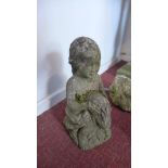 A reconstituted stone garden ornament in the form of a girl holding a rabbit, H.36cm