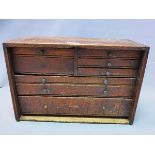 An early 20th century oak table top chest, with eight drawers, H.31 W.46 D.20 cm